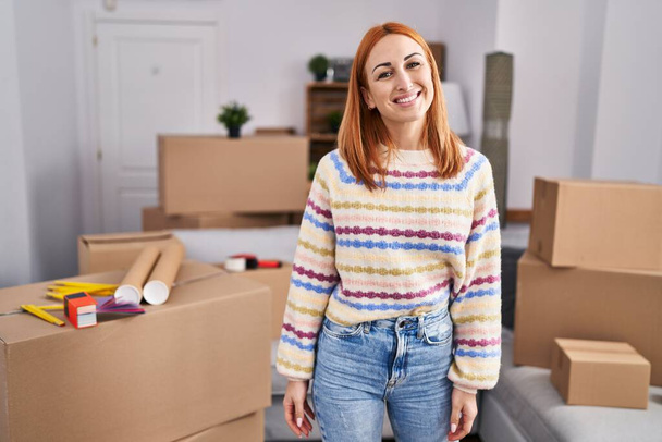 Young caucasian woman smiling confident standing at new home - Fotó, kép