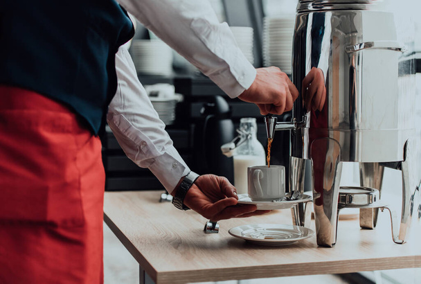 The waiter preparing coffee for hotel guests. Close up photo of service in modern hotels.  - Фото, зображення