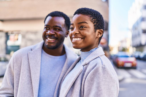 Man and woman couple smiling confident standing together at street - Photo, image