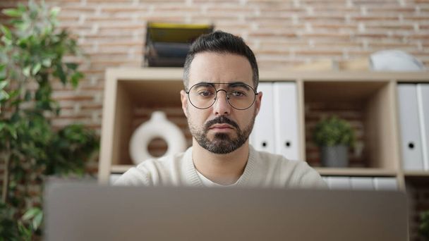 Young hispanic man business worker using laptop working at office - Photo, image