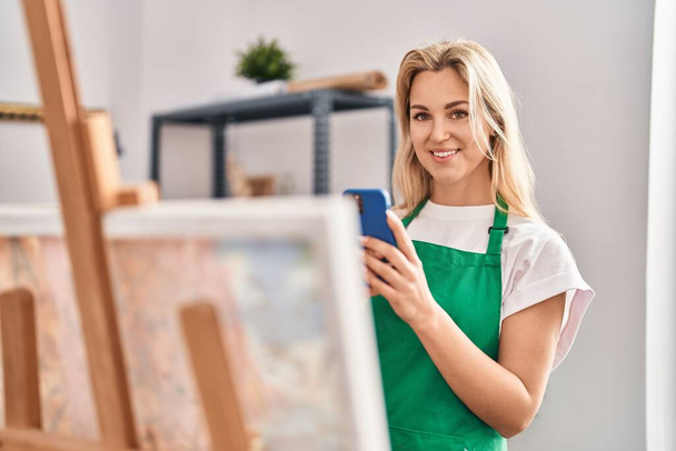 Young blonde woman artist make picture to draw at art studio - Photo, Image