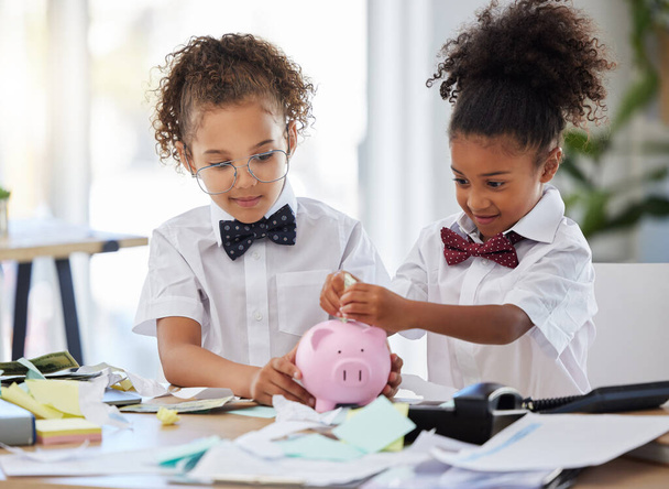 Saving, investment and girls pretending to be business people and learning about finance with a piggybank. Happy, banking and young children playing pretend as bankers with security of cash together. - Foto, Imagem
