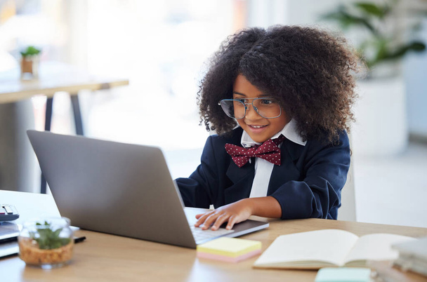 Laptop, szczęśliwy i dziecko udające pracownika, czytające e-maile i bawiące się na komputerze. Uśmiech, spryt i mała dziewczynka pisząca na komputerze, żeby udawać i działać jako pracownik biurowy.. - Zdjęcie, obraz