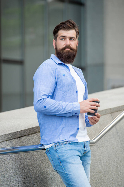bearded man with morning coffee outside. man with morning coffee in the street. photo of man with morning coffee. man with morning coffee outdoor. - Foto, imagen