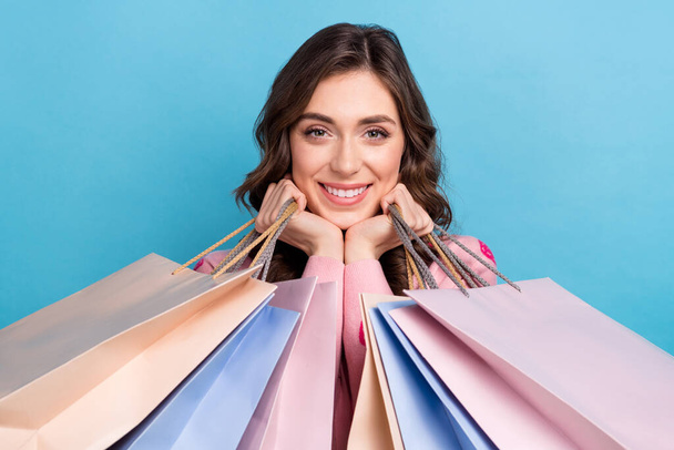 Foto retrato de atractivas bolsas de compras de mujer tocan las mejillas usan traje de impresión de fresa rosa de moda aislado en el fondo de color azul. - Foto, Imagen