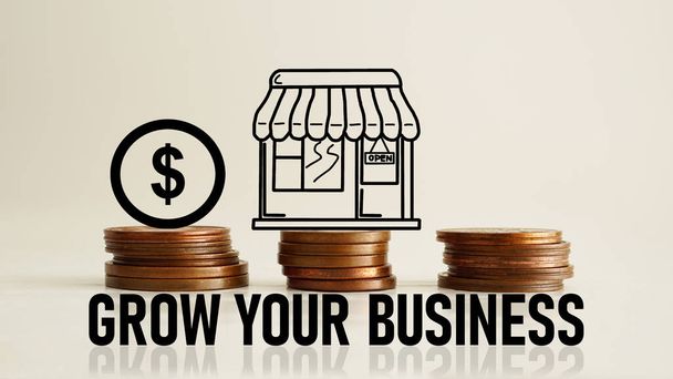 Grow your business is shown using a text and the photo of coins with the picture of shop - Photo, image