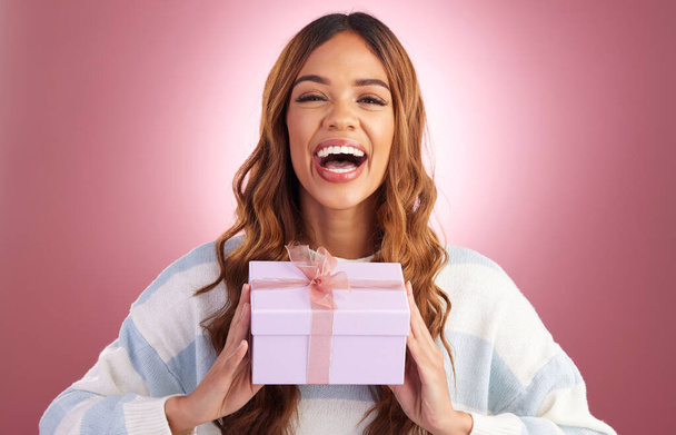 Woman, gift and box in studio portrait with happiness, surprise and celebration by gradient background. Student girl, young and happy with present package, excited face and celebrate for birthday. - Foto, afbeelding