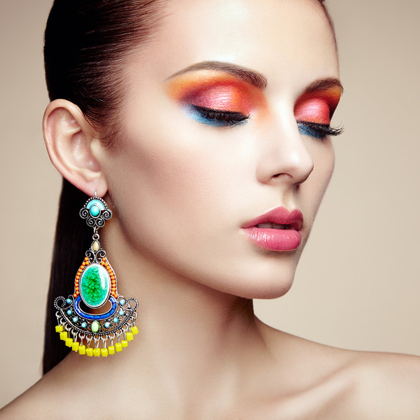 Portrait of beautiful young woman with earring - Fotoğraf, Görsel