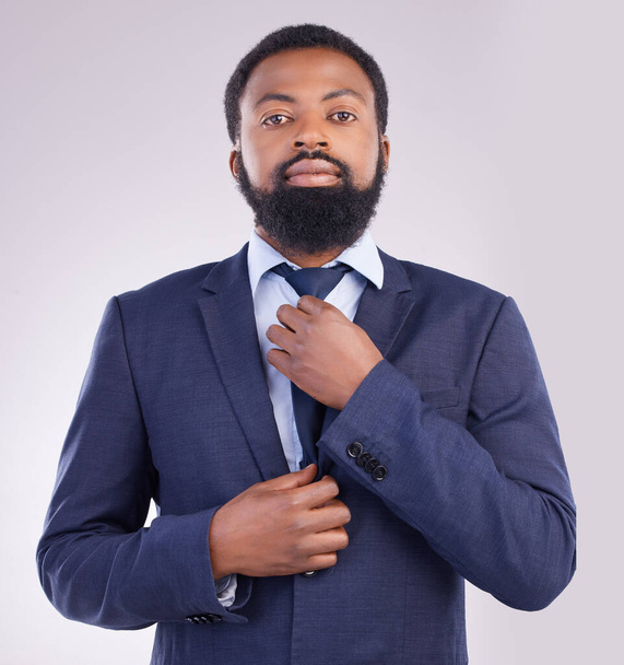 Portrait, business and black man fixing tie in studio isolated on a gray background. Ceo, entrepreneur and confident, proud or serious male professional from South Africa with pride for career or job. - Foto, Imagem