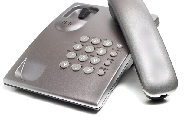 Стаціонарний телефон сірого на білому тлі
 - Фото, зображення