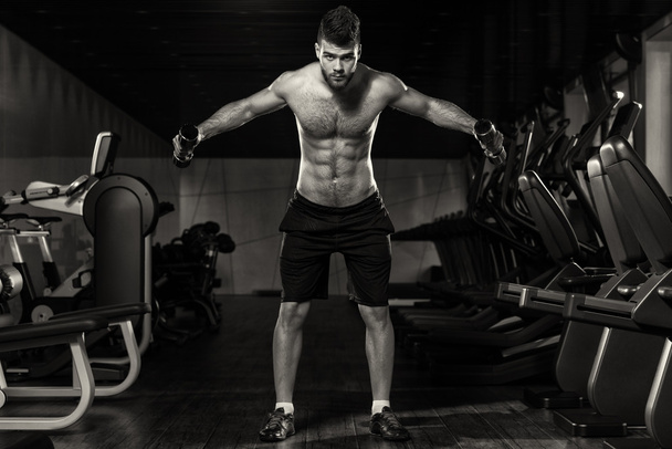 Young Man Exercising Shoulders With Dumbbells - Foto, Imagem