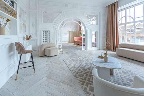 snow-white luxury apartment interior with Egyptian-style decor with light stylish furniture. huge panoramic windows and an archway. minimalism and simplicity with the elegance of modern housing design - Zdjęcie, obraz