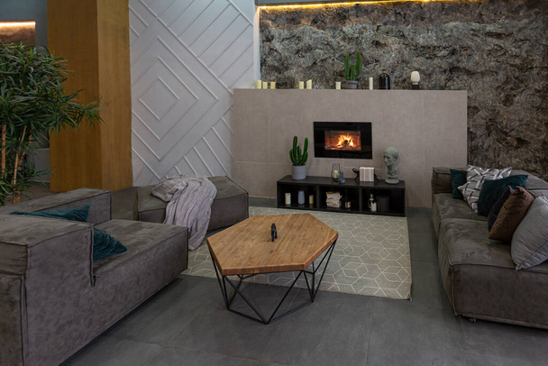 modern studio interior with decorative stone walls in grey. stone wood, tiles and led lighting in the design of the room - Fotó, kép
