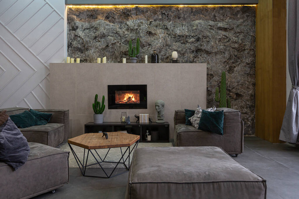 modern studio interior with decorative stone walls in grey. stone wood, tiles and led lighting in the design of the room - Fotó, kép