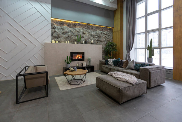 modern studio interior with decorative stone walls in grey. stone wood, tiles and led lighting in the design of the room - Valokuva, kuva