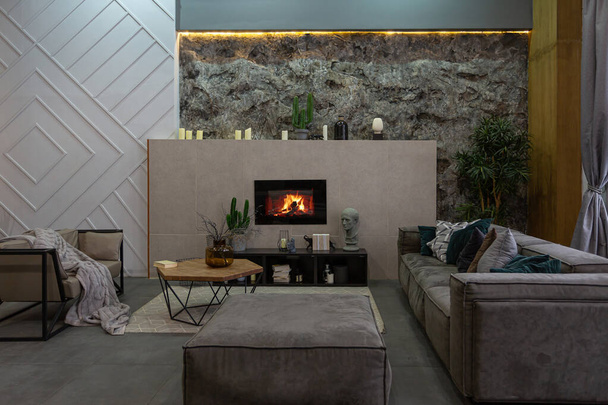 modern studio interior with decorative stone walls in grey. stone wood, tiles and led lighting in the design of the room. - 写真・画像