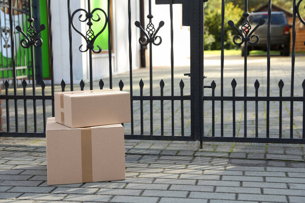 Stack of parcels delivered near front gates - Fotó, kép