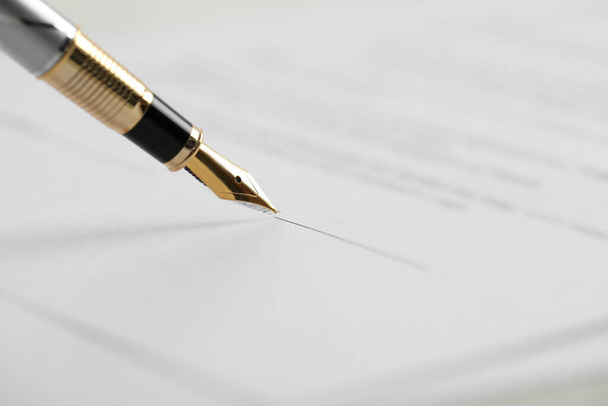 Signing document with fountain pen, closeup. Notary services - Photo, Image