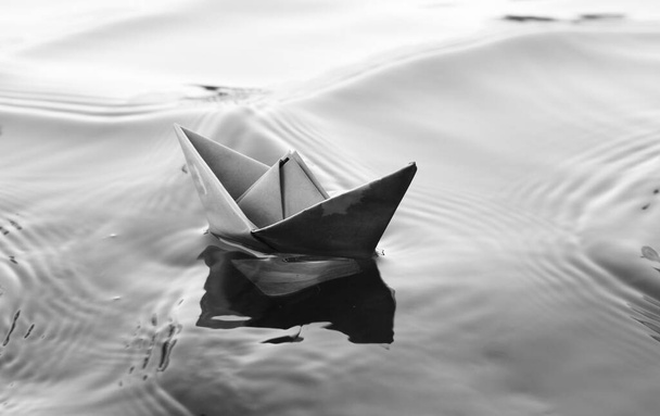 close up of a boat, floating in a puddle in the water. background with reflection. - Fotó, kép