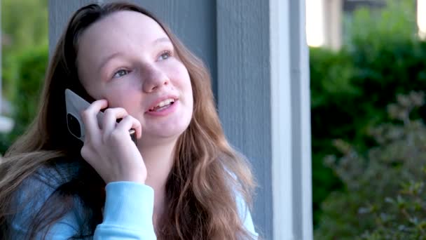 adolescents parlant sur le téléphone ragots histoires nouvelles communication sur l'école sur les amis communication avec les copines jeune fille parlant sur le téléphone utilise gadget blouse bleue en plein air se trouve - Séquence, vidéo
