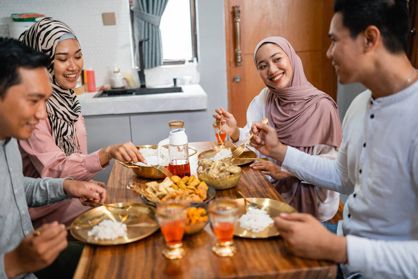 happy muslim friends having iftar dinner together at home - Photo, image