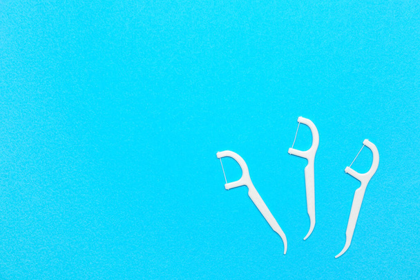 Floss toothpicks on blue background - Photo, Image