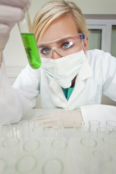 Female Scientist With Test Tube of Green Liquid In Laboratory - Valokuva, kuva