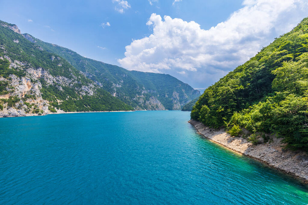 Wide angle panorama view of Piva lake Pivske Jezero in Montenegro at summer noon - Foto, Imagen