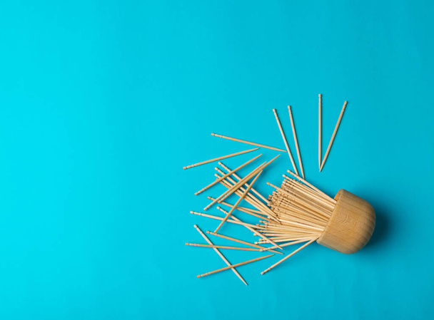 Wooden Toothpicks on Blue Background with Copy Space, Flat Lay Tooth Picks, Wood Toothpicks Top View Mockup with Space for Text, Daily Dental Care Concept Banner - 写真・画像