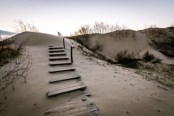 Parnidis sand dune in sunset. Sandy stairs to th Curonian spit, Nida city, Lithuania. - Фото, изображение