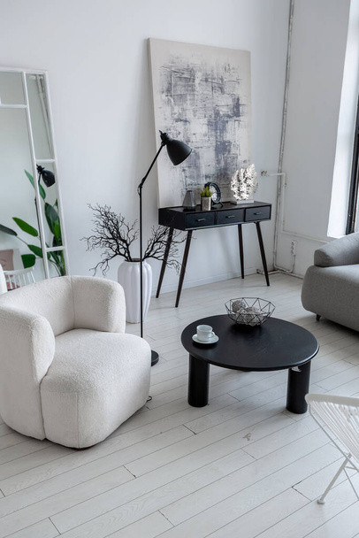 modern minimalistic interior design of light bright monochrome room with black and white furniture, clean white walls and huge windows - Foto, Bild