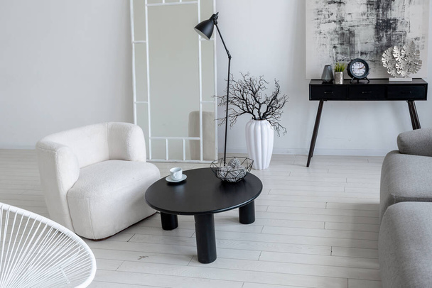 modern minimalistic interior design of light bright monochrome room with black and white furniture, clean white walls and huge windows - Zdjęcie, obraz