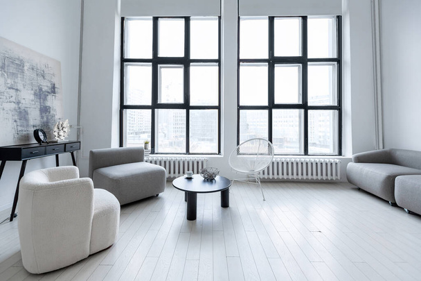 modern minimalistic interior design of light bright monochrome room with black and white furniture, clean white walls and huge windows - Valokuva, kuva