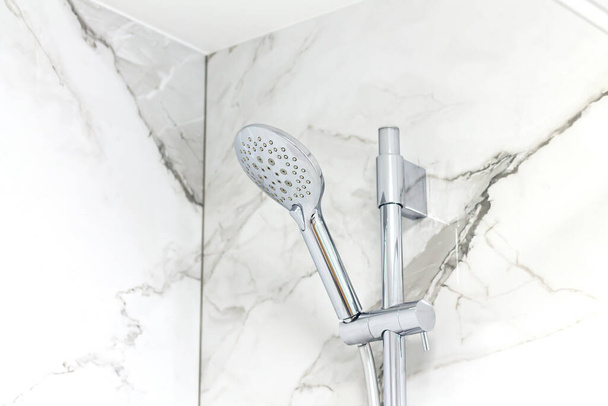 Modern shower head on marble bathroom wall background - Valokuva, kuva