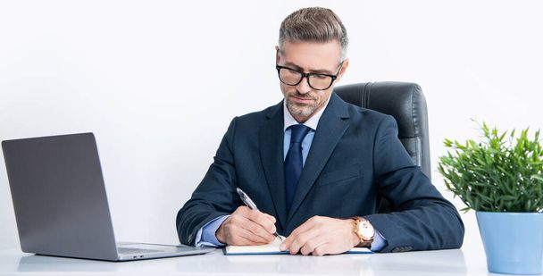 mature businessman in boss office making notes. - Photo, Image