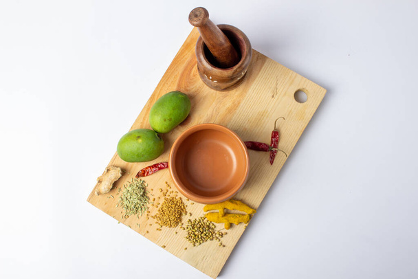 Mango Pickle setup with spice on wooden board - Photo, Image