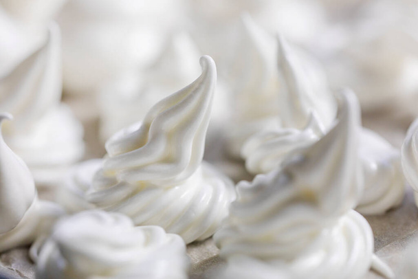 close-up of classic white meringue laid out on foil before baking. Festive mood - Фото, зображення