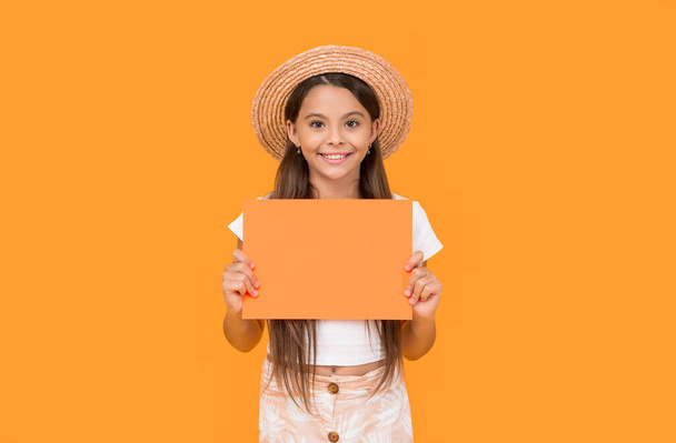 smiling teen girl with copy space on orange paper on yellow background. - Fotoğraf, Görsel