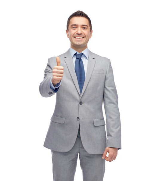 happy businessman in suit showing thumbs up - Фото, зображення