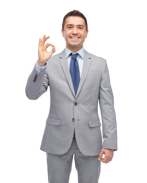 happy businessman in suit showing ok hand sign - Fotó, kép