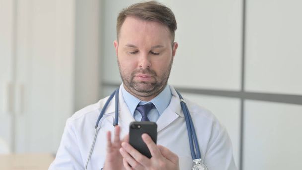 Porträt eines jungen Arztes mit Smartphone - Foto, Bild