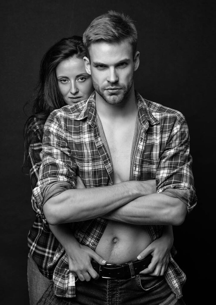 guy and girl together. togetherness. concept of romantic relationship. fashion and beauty. passionate sexy couple in love on black background. young people. man and woman embracing. - Фото, зображення