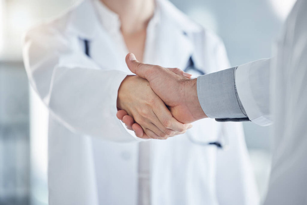 Handshake, medical and doctors have agreement on patient health, illness treatment plan or diagnosis in clinic. Professional nurse, promotion or solution for virus, medicine or healthcare in hospital. - Photo, Image