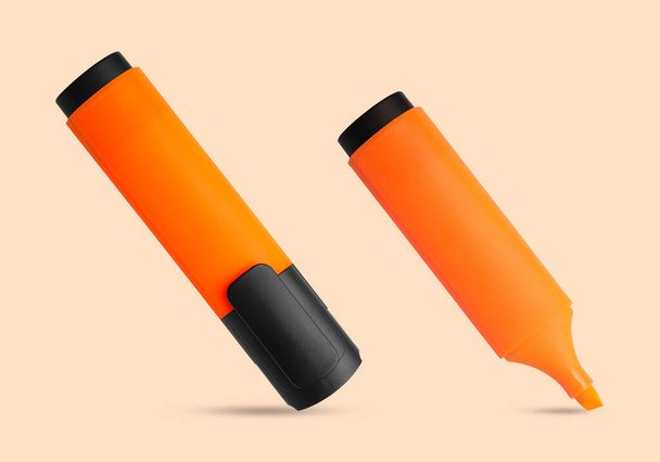 Two orange markers on beige background. Highlighter - Photo, Image