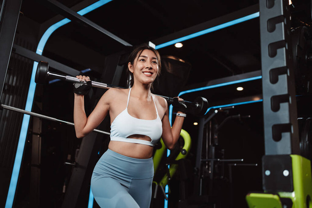 Woman working out Bodybuilder with barbell weights at the gym. bodybuilder doing exercises with barbell. training sport healthy lifestyle bodybuilding, Athlete builder muscles lifestyle. - 写真・画像