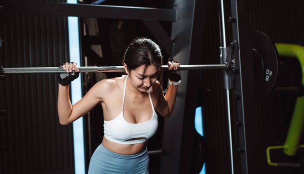 Woman working out Bodybuilder with barbell weights at the gym. bodybuilder doing exercises with barbell. training sport healthy lifestyle bodybuilding, Athlete builder muscles lifestyle. - Zdjęcie, obraz