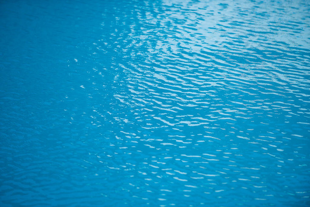 Blue pool water background. Blurred transparent clear calm water surface texture. Water waves in sunlight with copy space - Foto, Imagem