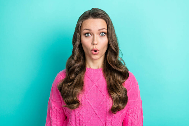Photo of impressed astonished woman with wavy hairdo dressed knitwear sweater staring open mouth isolated on teal color background. - Zdjęcie, obraz