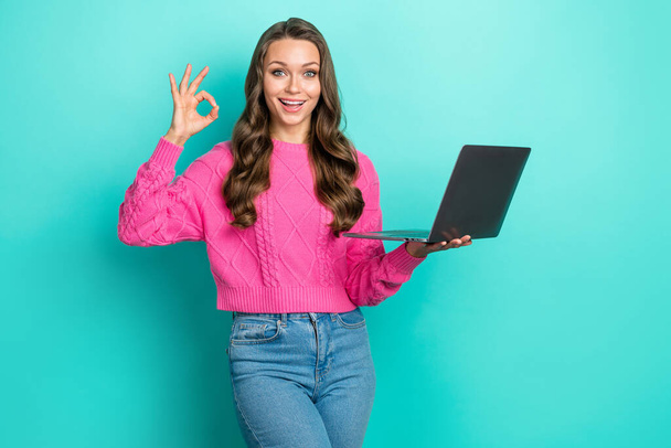 Photo of lovely satisfied woman with wavy hairdo dressed knitwear sweater hold laptop showing okey isolated on teal color background. - Valokuva, kuva
