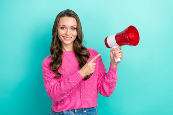 Photo of pretty adorable lady dressed knitted pullover pointing finger loudspeaker empty space isolated teal color background. - Foto, Imagen